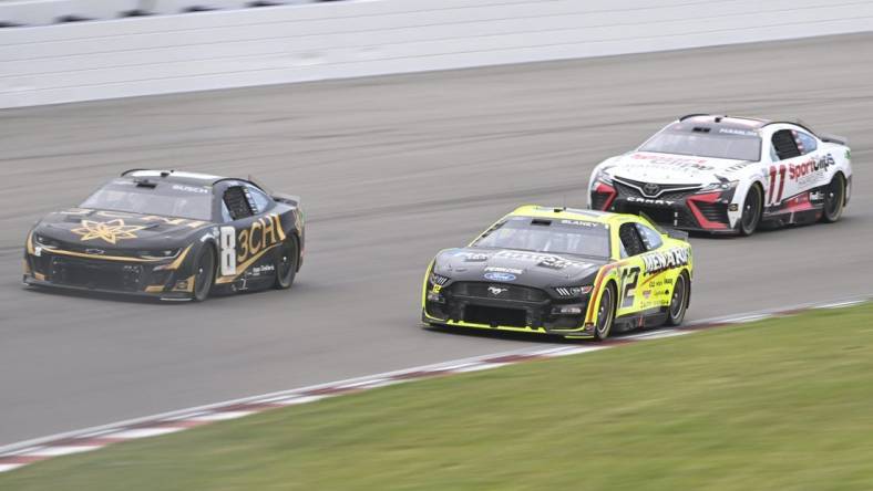 Jun 4, 2023; Madison, Illinois, USA; NASCAR Cup Series driver Kyle Busch (8) leads NASCAR Cup Series driver Ryan Blaney (12) and NASCAR Cup Series driver Denny Hamlin (11) during the Enjoy Illinois 300 at World Wide Technology Raceway. Mandatory Credit: Joe Puetz-USA TODAY Sports