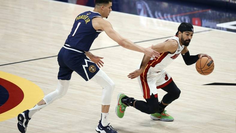 Jun 4, 2023; Denver, CO, USA; Miami Heat guard Gabe Vincent (2) controls the ball against Denver Nuggets forward Michael Porter Jr. (1) in the first half in game two of the 2023 NBA Finals at Ball Arena. Mandatory Credit: Isaiah J. Downing-USA TODAY Sports