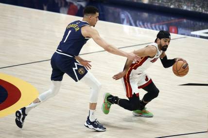 Jun 4, 2023; Denver, CO, USA; Miami Heat guard Gabe Vincent (2) controls the ball against Denver Nuggets forward Michael Porter Jr. (1) in the first half in game two of the 2023 NBA Finals at Ball Arena. Mandatory Credit: Isaiah J. Downing-USA TODAY Sports