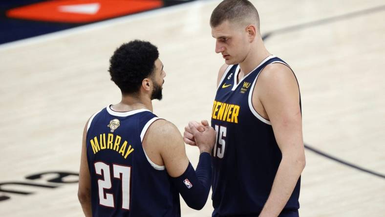 Jun 4, 2023; Denver, CO, USA; Denver Nuggets center Nikola Jokic (15) and guard Jamal Murray (27) react in the second quarter against the Miami Heat in game two of the 2023 NBA Finals at Ball Arena. Mandatory Credit: Isaiah J. Downing-USA TODAY Sports