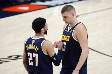 Jun 4, 2023; Denver, CO, USA; Denver Nuggets center Nikola Jokic (15) and guard Jamal Murray (27) react in the second quarter against the Miami Heat in game two of the 2023 NBA Finals at Ball Arena. Mandatory Credit: Isaiah J. Downing-USA TODAY Sports