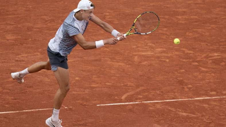 Jun 5 2023; Paris, France; Holger Rune (DEN) returns a shot against Francisco Cerundolo (ARG) on day nine at Stade Roland-Garros. Mandatory Credit: Susan Mullane-USA TODAY Sports