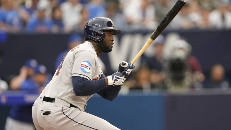 Jun 5, 2023; Toronto, Ontario, CAN; Houston Astros designated hitter Yordan Alvarez (44) hits an RBI single against the Toronto Blue Jays during the first inning at Rogers Centre. Mandatory Credit: John E. Sokolowski-USA TODAY Sports