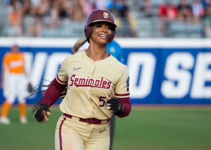 Jun 5, 2023; Oklahoma City, OK, USA;  Florida State Seminoles catcher Michaela Edenfield (51) reacts as she rounds the bases after a home run in the second inning against the Tennessee Lady Vols during the semifinal game at OGE Energy Field at the USA Softball Hall of Fame Complex. Mandatory Credit: Brett Rojo-USA TODAY Sports