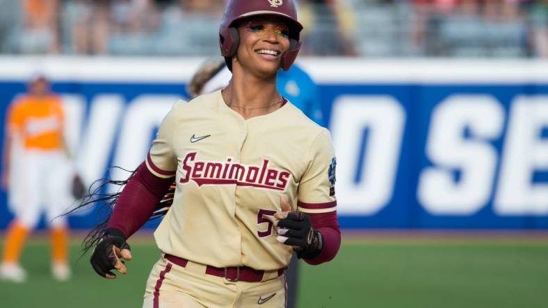 Jun 5, 2023; Oklahoma City, OK, USA;  Florida State Seminoles catcher Michaela Edenfield (51) reacts as she rounds the bases after a home run in the second inning against the Tennessee Lady Vols during the semifinal game at OGE Energy Field at the USA Softball Hall of Fame Complex. Mandatory Credit: Brett Rojo-USA TODAY Sports