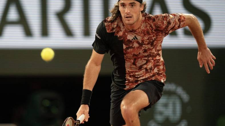 Jun 6 2023; Paris, France; Stefanos Tsitsipas (GRE) runs for the ball during a match against Carlos Alcaraz (ESP) on day 10 at Stade Roland-Garros. Mandatory Credit: Susan Mullane-USA TODAY Sports