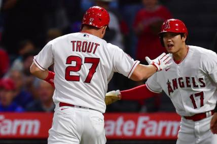 Jun 6, 2023; Anaheim, California, USA; Los Angeles Angels center fielder Mike Trout (27) is greeted by designated hitter Shohei Ohtani (17) after scoring a run against the Chicago Cubs during the fifth inning at Angel Stadium. Mandatory Credit: Gary A. Vasquez-USA TODAY Sports