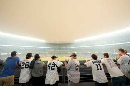 Yankee fans watch the game against the White Sox as a thick haze from the Canadian wildfires hover over the Bronx on June 6, 2023.