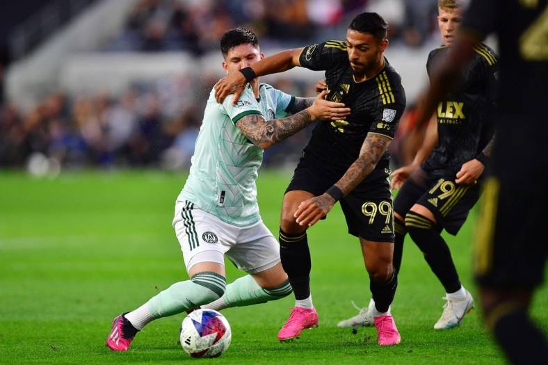 Jun 7, 2023; Los Angeles, California, USA; Los Angeles FC forward Denis Bouanga (99) moves in for the ball against Atlanta United midfielder Franco Ibarra (14) during the first half at BMO Stadium. Mandatory Credit: Gary A. Vasquez-USA TODAY Sports