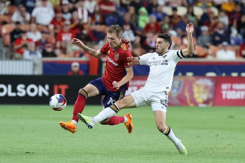 Jun 7, 2023; Sandy, UT, USA; Real Salt Lake midfielder Bode Hidalgo (19) and Los Angeles Galaxy midfielder Gast n Brugman (5) play for a ball in the second half at America First Field. Mandatory Credit: Rob Gray-USA TODAY Sports