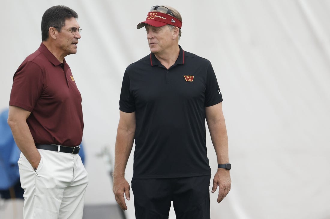 Jun 8, 2023; Ashburn, Virginia, USA; Washington Commanders head coach Ron Rivera (L) talks with Commanders defensive coordinator Jack Del Rio (R) on day three of minicamp at OrthoVirginia Training Center at Commanders Park, held inside the training bubble due to poor air quality from Canadian wildfire smoke in Ashburn. Mandatory Credit: Geoff Burke-USA TODAY Sports