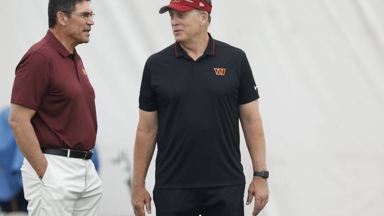 Jun 8, 2023; Ashburn, Virginia, USA; Washington Commanders head coach Ron Rivera (L) talks with Commanders defensive coordinator Jack Del Rio (R) on day three of minicamp at OrthoVirginia Training Center at Commanders Park, held inside the training bubble due to poor air quality from Canadian wildfire smoke in Ashburn. Mandatory Credit: Geoff Burke-USA TODAY Sports