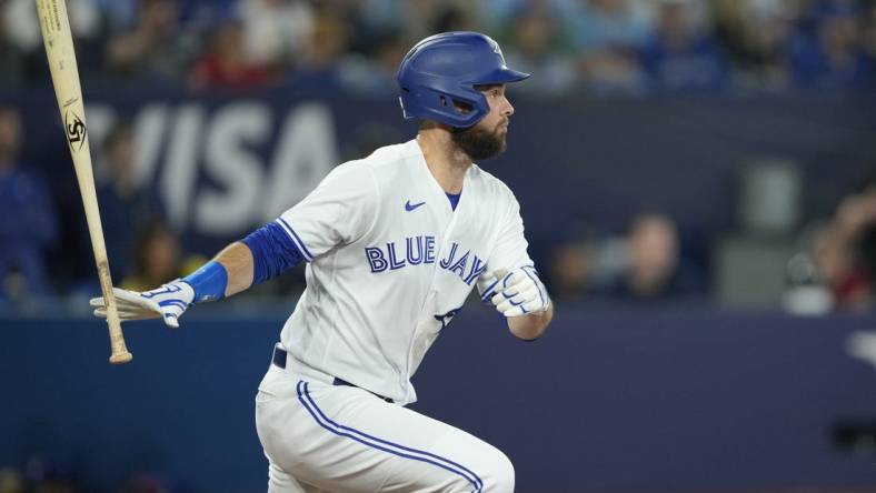 Jun 8, 2023; Toronto, Ontario, CAN; Toronto Blue Jays designated hitter Brandon Belt (13) hits an RBI single against the Houston Astros during the fifth inning at Rogers Centre. Mandatory Credit: John E. Sokolowski-USA TODAY Sports