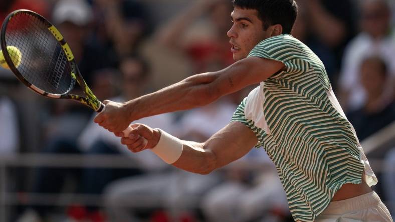 Jun 9 2023; Paris,France; Carlos Alcaraz (ESP) returns a shot during his semifinal match against Novak Djokovic (SRB) on day 13 at Stade Roland-Garros. Mandatory Credit: Susan Mullane-USA TODAY Sports