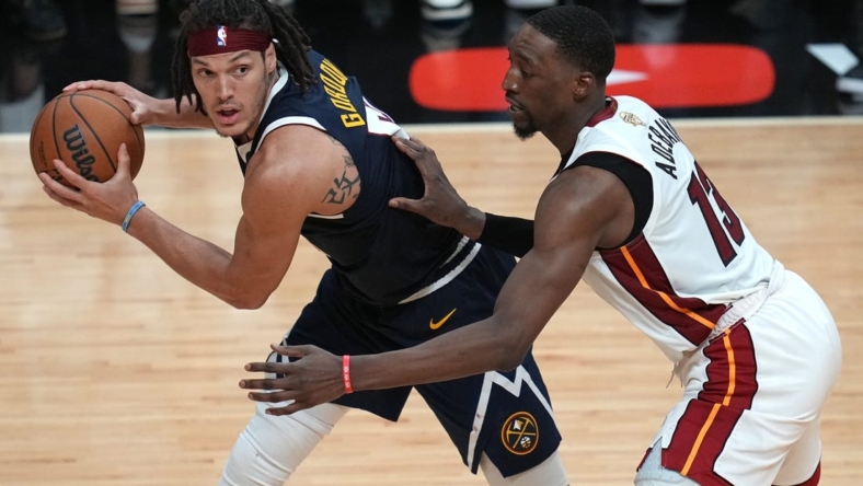 Jun 9, 2023; Miami, Florida, USA; Denver Nuggets forward Aaron Gordon (50) controls the ball while defended by Miami Heat center Bam Adebayo (13) during the second half in game four of the 2023 NBA Finals at Kaseya Center. Mandatory Credit: Jim Rassol-USA TODAY Sports