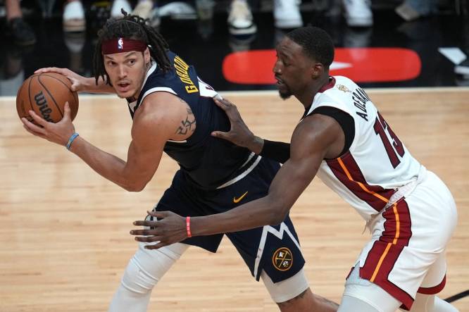 Jun 9, 2023; Miami, Florida, USA; Denver Nuggets forward Aaron Gordon (50) controls the ball while defended by Miami Heat center Bam Adebayo (13) during the second half in game four of the 2023 NBA Finals at Kaseya Center. Mandatory Credit: Jim Rassol-USA TODAY Sports