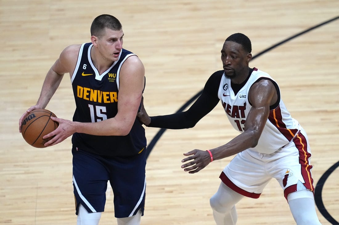 Jun 9, 2023; Miami, Florida, USA; Denver Nuggets center Nikola Jokic (15) controls the ball while defended by Miami Heat center Bam Adebayo (13) during the second half in game four of the 2023 NBA Finals at Kaseya Center. Mandatory Credit: Jim Rassol-USA TODAY Sports
