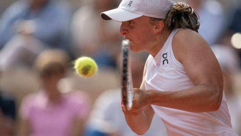 Jun 10, 2023; Paris,France; Iga Swiatek (POL) returns a shot during the French Open final against Karolina Muchova (CZE) on day 14 at Stade Roland-Garros. Mandatory Credit: Susan Mullane-USA TODAY Sports