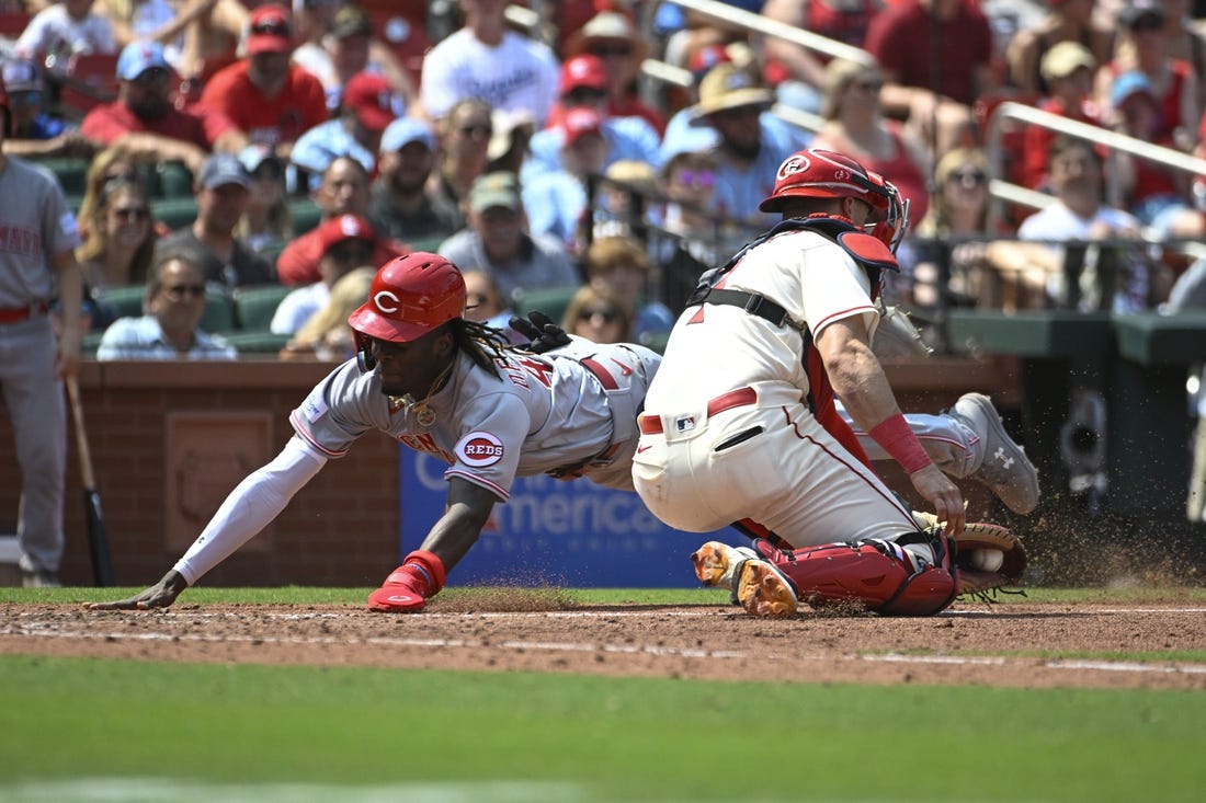 Jun 10, 2023; St. Louis, Missouri, USA; Cincinnati Reds third baseman Elly De La Cruz (44) slides safely into home ahead of the tag from St. Louis Cardinals catcher Andrew Knizner (7) in the seventh inning at Busch Stadium. Mandatory Credit: Joe Puetz-USA TODAY Sports