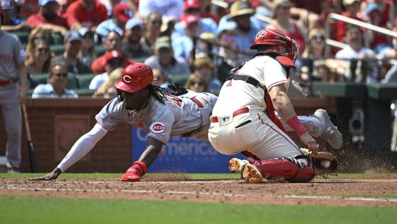 Jun 10, 2023; St. Louis, Missouri, USA; Cincinnati Reds third baseman Elly De La Cruz (44) slides safely into home ahead of the tag from St. Louis Cardinals catcher Andrew Knizner (7) in the seventh inning at Busch Stadium. Mandatory Credit: Joe Puetz-USA TODAY Sports