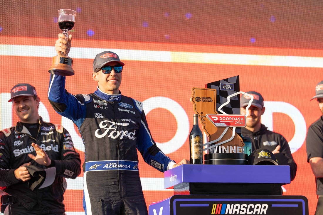 Jun 10, 2023; Sonoma, California, USA;  NASCAR Xfinity Series driver Aric Almirola (128) celebrates after winning the NASCAR Xfinity Series DoorDash 250 at Sonoma Raceway. Mandatory Credit: Stan Szeto-USA TODAY Sports