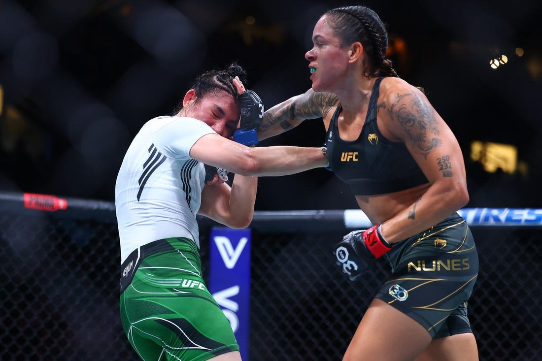 Jun 10, 2023; Vancouver, BC, Canada; Amanda Nunes lands a hit against Irene Aldana during UFC 289 at Rogers Arena. Mandatory Credit: Sergei Belski-USA TODAY Sports