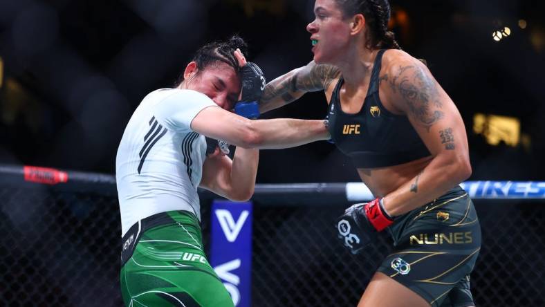 Jun 10, 2023; Vancouver, BC, Canada; Amanda Nunes lands a hit against Irene Aldana during UFC 289 at Rogers Arena. Mandatory Credit: Sergei Belski-USA TODAY Sports