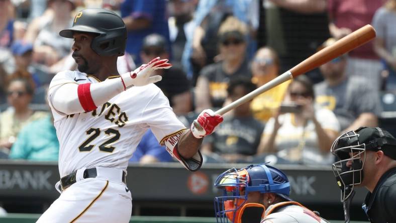 Jun 11, 2023; Pittsburgh, Pennsylvania, USA; Pittsburgh Pirates designated hitter Andrew McCutchen (22) hits a single to register his 2000th career major league hit during the first inning against the New York Mets at PNC Park. Mandatory Credit: Charles LeClaire-USA TODAY Sports