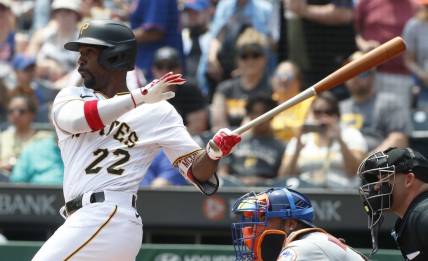 Jun 11, 2023; Pittsburgh, Pennsylvania, USA; Pittsburgh Pirates designated hitter Andrew McCutchen (22) hits a single to register his 2000th career major league hit during the first inning against the New York Mets at PNC Park. Mandatory Credit: Charles LeClaire-USA TODAY Sports