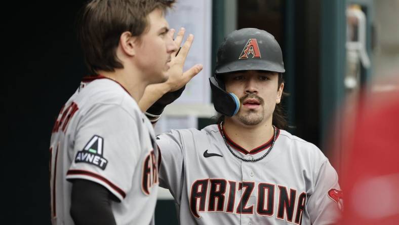 Jun 11, 2023; Detroit, Michigan, USA;  Arizona Diamondbacks left fielder Corbin Carroll (7) receives congratulations from teammates after scoring against the Detroit Tigers at Comerica Park. Mandatory Credit: Rick Osentoski-USA TODAY Sports