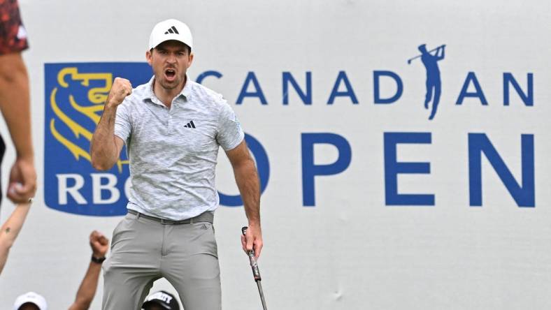 Jun 11, 2023; Toronto, ON, CAN;  Nick Taylor reacts after sinking a birdie putt on the 18th green to take the tournament lead during the final round of the RBC Canadian Open golf tournament. Mandatory Credit: Dan Hamilton-USA TODAY Sports