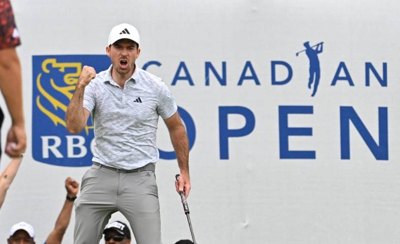 Jun 11, 2023; Toronto, ON, CAN;  Nick Taylor reacts after sinking a birdie putt on the 18th green to take the tournament lead during the final round of the RBC Canadian Open golf tournament. Mandatory Credit: Dan Hamilton-USA TODAY Sports