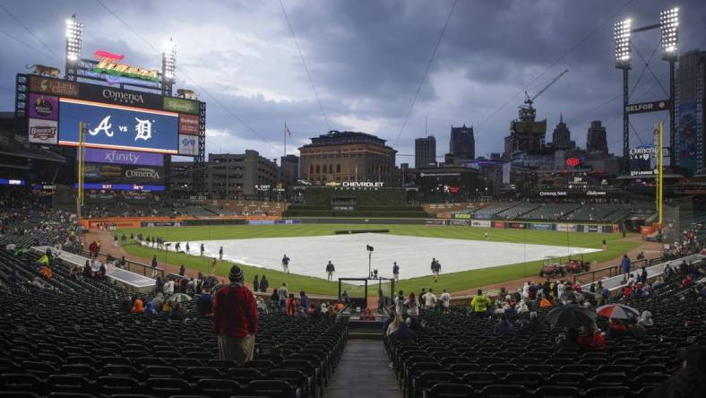 Jun 13, 2023; Detroit, Michigan, USA; The Detroit Tigers grounds crew works to put the tarp on the field during a rain delay at Comerica Park. Mandatory Credit: Brian Bradshaw Sevald-USA TODAY Sports