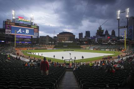 Jun 13, 2023; Detroit, Michigan, USA; The Detroit Tigers grounds crew works to put the tarp on the field during a rain delay at Comerica Park. Mandatory Credit: Brian Bradshaw Sevald-USA TODAY Sports
