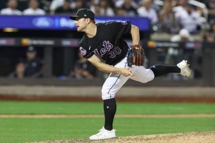 Jun 13, 2023; New York City, New York, USA; New York Mets relief pitcher David Robertson (30) delivers a pitch  during the ninth inning against the New York Yankees at Citi Field. Mandatory Credit: Vincent Carchietta-USA TODAY Sports