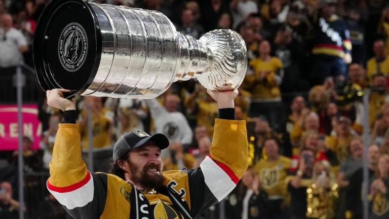 Jun 13, 2023; Las Vegas, Nevada, USA; Vegas Golden Knights forward Mark Stone (61) hoists the Stanley Cup after defeating the Florida Panthers in game five of the 2023 Stanley Cup Final at T-Mobile Arena. Mandatory Credit: Stephen R. Sylvanie-USA TODAY Sports