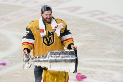 Jun 13, 2023; Las Vegas, Nevada, USA; Vegas Golden Knights goaltender Adin Hill (33) hoists the Stanley Cup after defeating the Florida Panthers in game five of the 2023 Stanley Cup Final at T-Mobile Arena. Mandatory Credit: Lucas Peltier-USA TODAY Sports