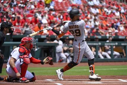 Jun 14, 2023; St. Louis, Missouri, USA;  San Francisco Giants center fielder Luis Matos (29) hits a single in his Major League debut against the St. Louis Cardinals during the first inning at Busch Stadium. Mandatory Credit: Jeff Curry-USA TODAY Sports