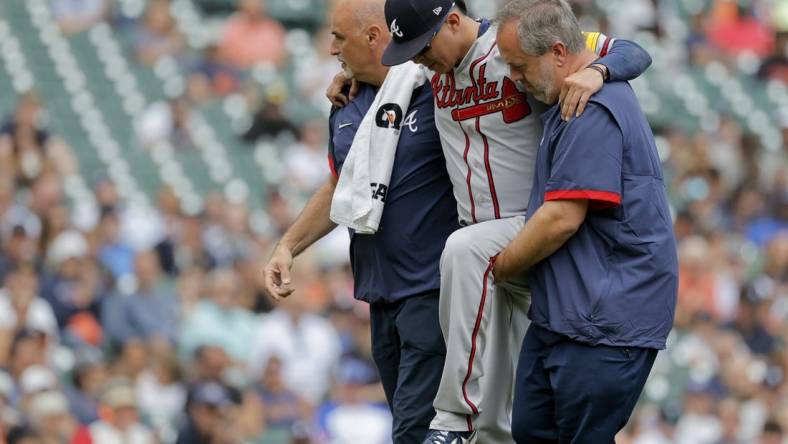 Jun 14, 2023; Detroit, Michigan, USA;  Atlanta Braves relief pitcher Jesse Chavez (60) is helped off the field after he is hit by a batted ball in the sixth inning against the Detroit Tigers at Comerica Park. Mandatory Credit: Rick Osentoski-USA TODAY Sports