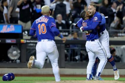 Jun 14, 2023; New York City, New York, USA; New York Mets center fielder Brandon Nimmo (9) celebrates with shortstop Francisco Lindor (12) and third baseman Eduardo Escobar (10) after hitting a tenth inning walkoff double against the New York Yankees at Citi Field. Mandatory Credit: Brad Penner-USA TODAY Sports