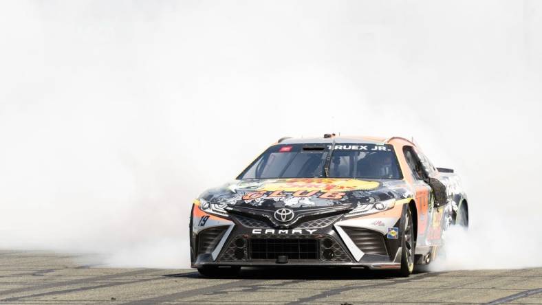 Jun 11, 2023; Sonoma, California, USA;  NASCAR Cup Series driver Martin Truex Jr. (19) celebrates after winning the Toyota / Save Mart 350 at Sonoma Raceway. Mandatory Credit: Stan Szeto-USA TODAY Sports