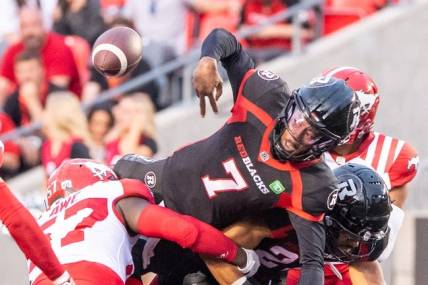 Jun 15, 2023; Ottawa, Ontario, CAN; Ottawa REDBLACKS quarterback Tyrie Adams (7) loses control of the ball in the first half against the  Calgary Stampeders at TD Place. Mandatory Credit: Marc DesRosiers-USA TODAY Sports