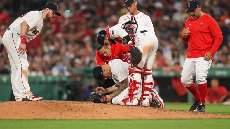 Jun 16, 2023; Boston, Massachusetts, USA; Boston Red Sox starting pitcher Tanner Houck (89) reacts after getting hit in the face with a line drive during the fifth inning against the New York Yankees at Fenway Park. Mandatory Credit: Paul Rutherford-USA TODAY Sports