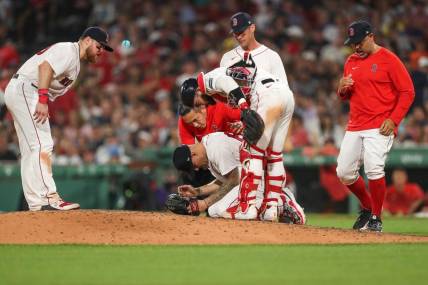 Jun 16, 2023; Boston, Massachusetts, USA; Boston Red Sox starting pitcher Tanner Houck (89) reacts after getting hit in the face with a line drive during the fifth inning against the New York Yankees at Fenway Park. Mandatory Credit: Paul Rutherford-USA TODAY Sports