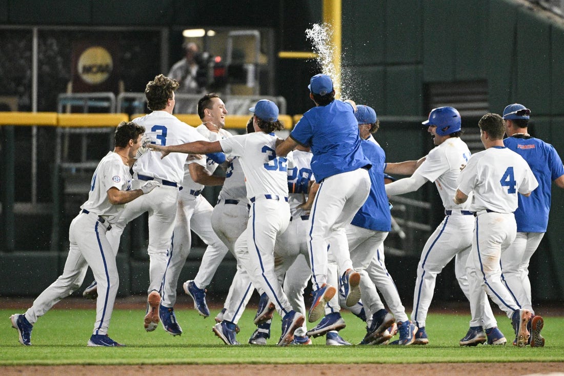 Jun 16, 2023; Omaha, NE, USA; Florida Gators designated hitter Luke Heyman (28) celebrates with teammates after hitting a walk off sacrifice fly against the Virginia Cavaliers in the ninth inning at Charles Schwab Field Omaha. Mandatory Credit: Steven Branscombe-USA TODAY Sports