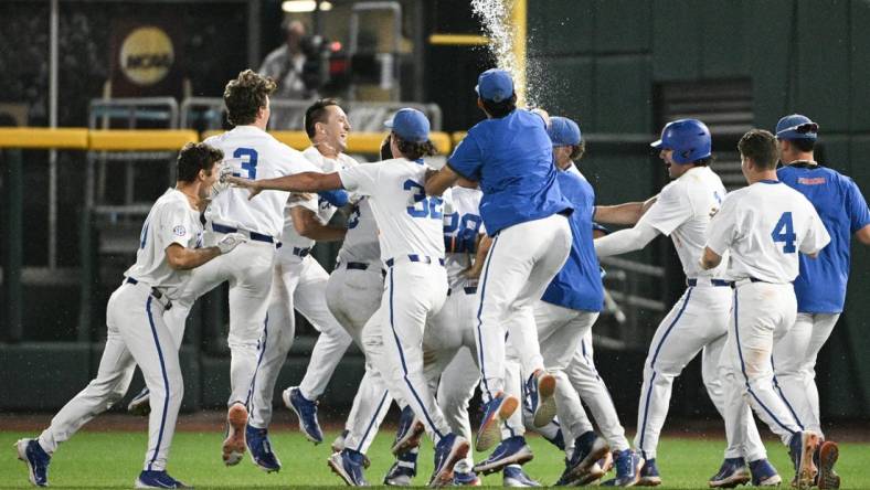 Jun 16, 2023; Omaha, NE, USA; Florida Gators designated hitter Luke Heyman (28) celebrates with teammates after hitting a walk off sacrifice fly against the Virginia Cavaliers in the ninth inning at Charles Schwab Field Omaha. Mandatory Credit: Steven Branscombe-USA TODAY Sports