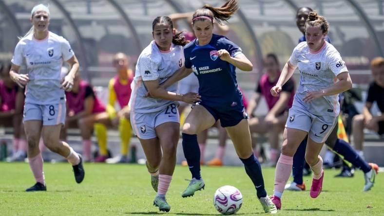 Jun 17, 2023; San Diego, California, USA; San Diego Wave FC defender Abby Dahlkemper (2), Angel City FC midfielder Lily Nabet (28), and Angel City FC midfielder Savannah McCaskill (9) battle for the ball during the first half at Snapdragon Stadium. Mandatory Credit: Ray Acevedo-USA TODAY Sports