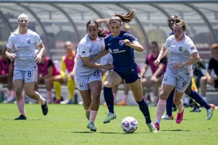 Jun 17, 2023; San Diego, California, USA; San Diego Wave FC defender Abby Dahlkemper (2), Angel City FC midfielder Lily Nabet (28), and Angel City FC midfielder Savannah McCaskill (9) battle for the ball during the first half at Snapdragon Stadium. Mandatory Credit: Ray Acevedo-USA TODAY Sports
