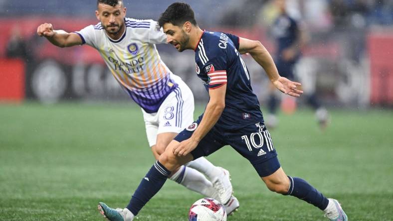 Jun 17, 2023; Foxborough, Massachusetts, USA; New England Revolution midfielder Carles Gil (10) controls the ball in front of Orlando City midfielder Felipe Martins (8) during the first half of a match at Gillette Stadium. Mandatory Credit: Brian Fluharty-USA TODAY Sports