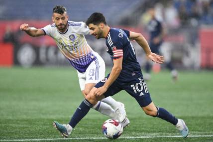 Jun 17, 2023; Foxborough, Massachusetts, USA; New England Revolution midfielder Carles Gil (10) controls the ball in front of Orlando City midfielder Felipe Martins (8) during the first half of a match at Gillette Stadium. Mandatory Credit: Brian Fluharty-USA TODAY Sports
